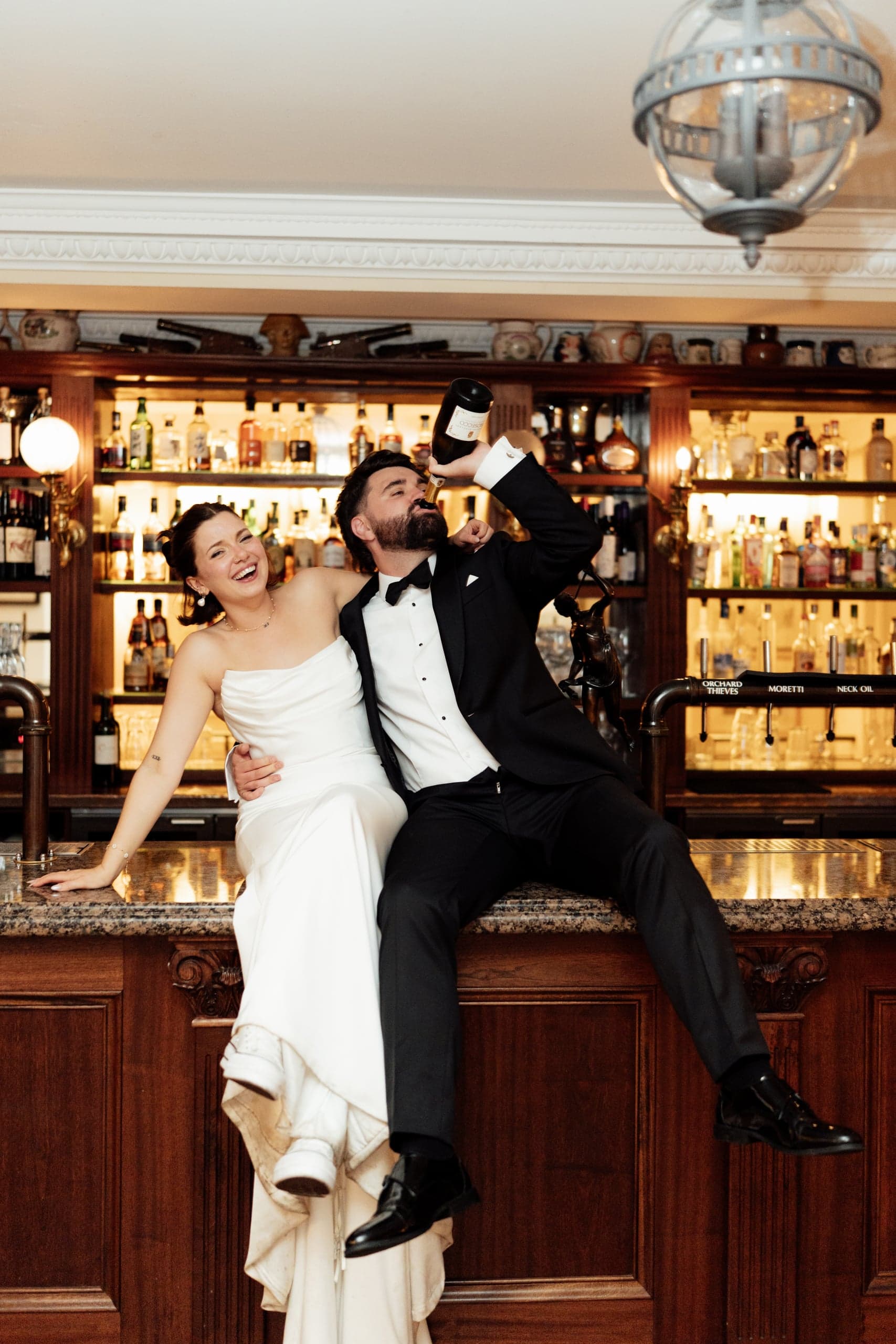 Kirsty and Jamie sharing drinks at the bar during their Trafalgar Tavern wedding reception