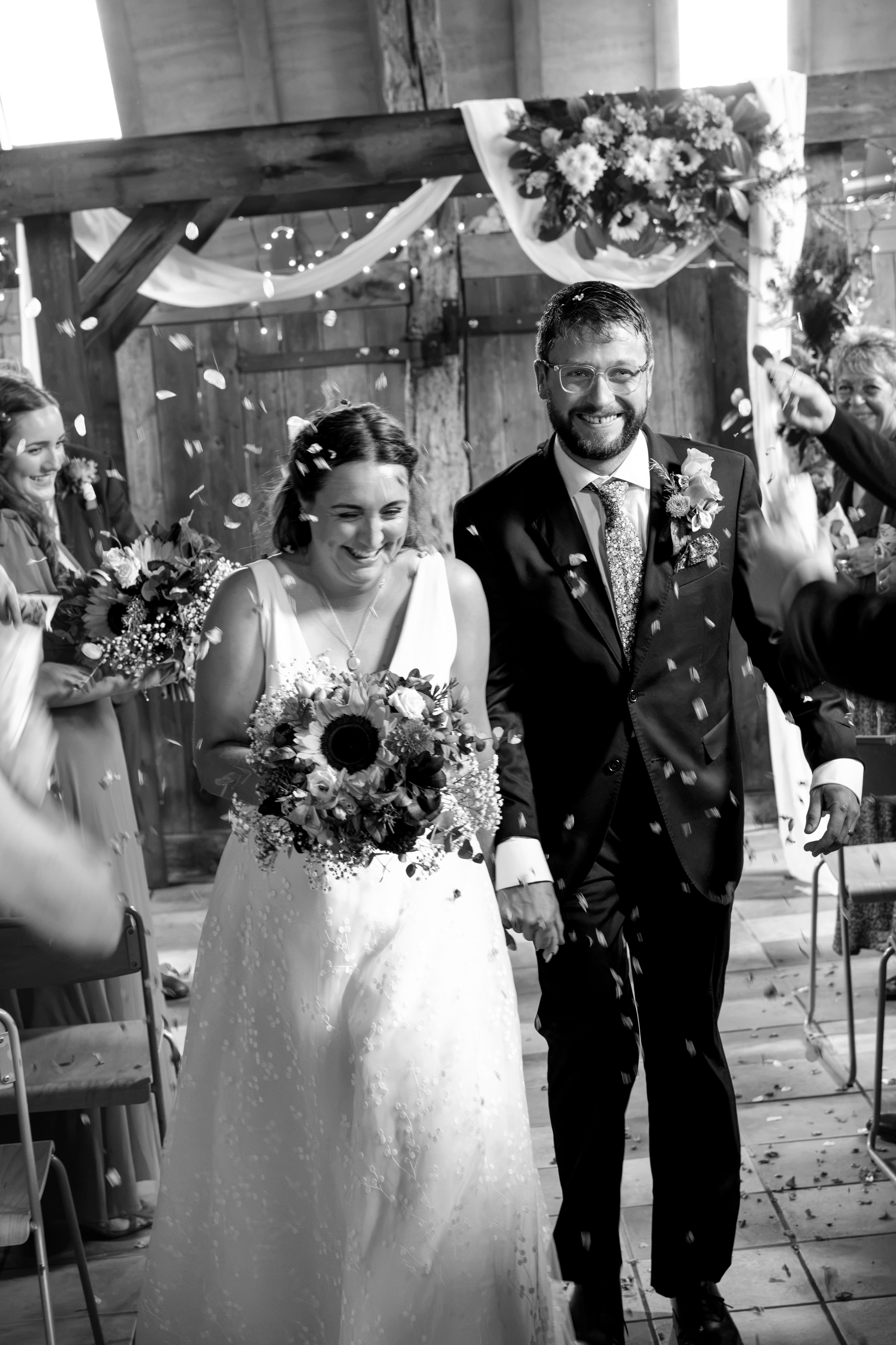 Black and white confetti moment of bride and groom