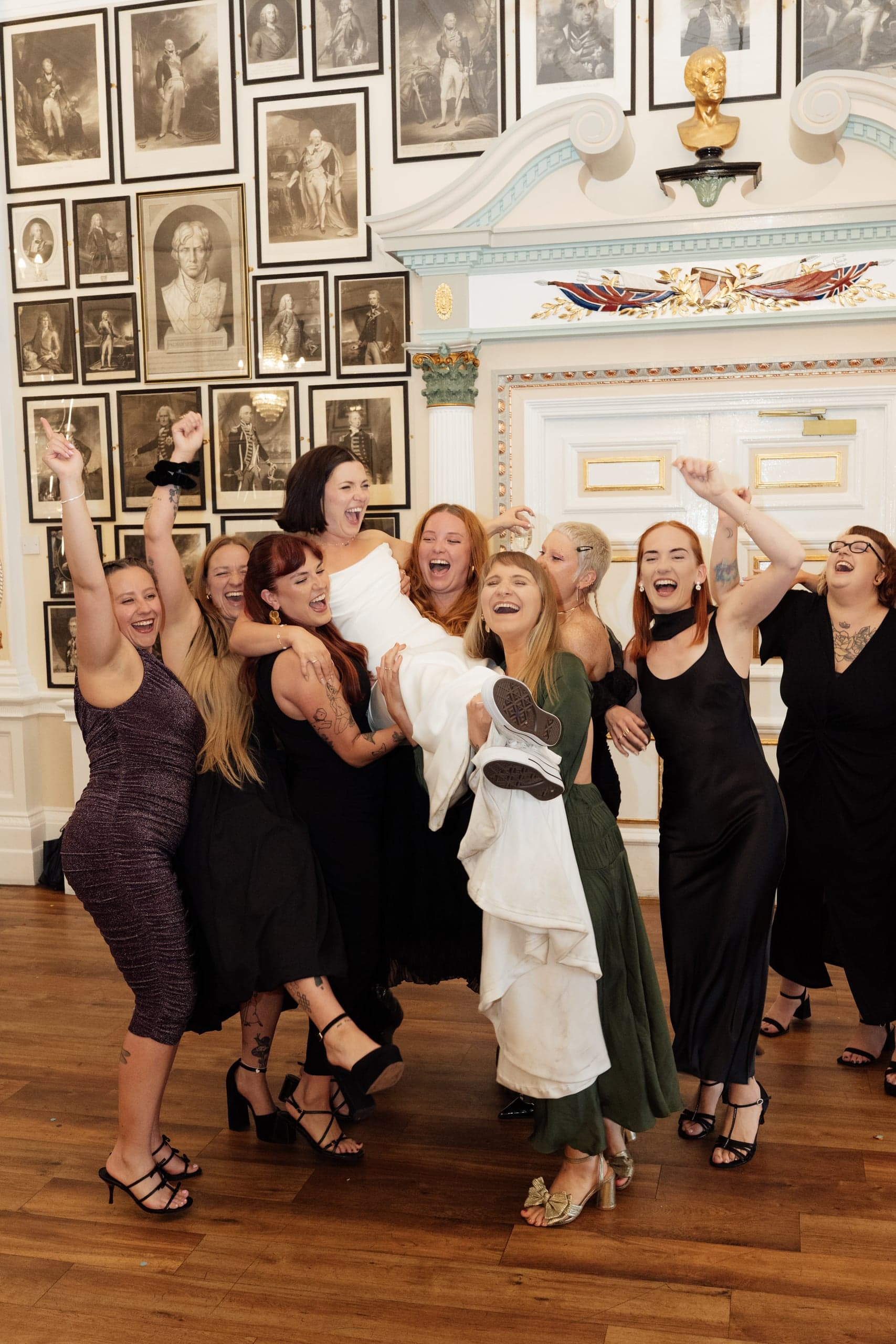 Kirsty being lifted by her bridesmaids while getting ready