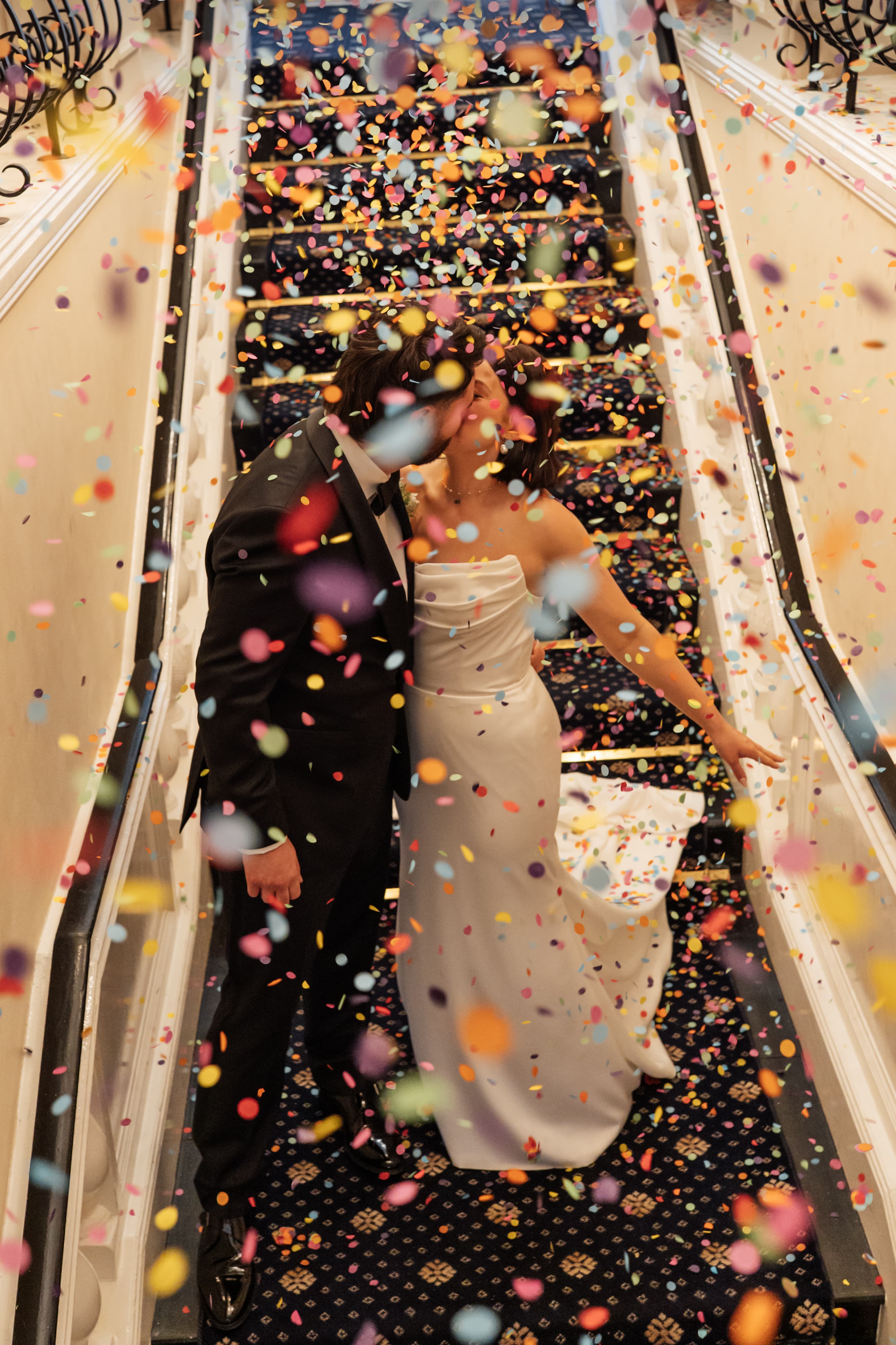 Joyful wedding confetti moment captured in natural documentary style