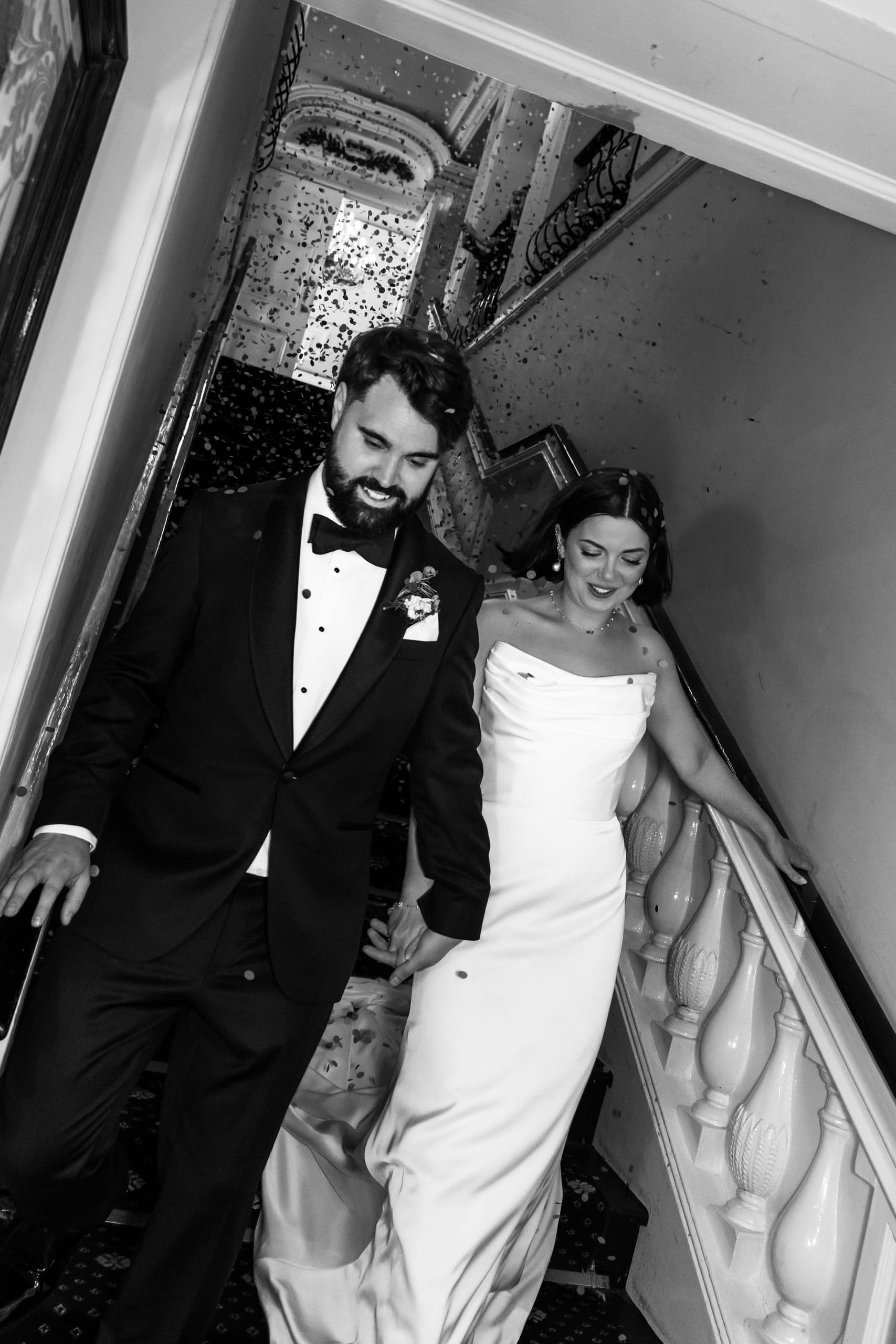 Kirsty and Jamie walking through confetti outside the Trafalgar Tavern after their ceremony