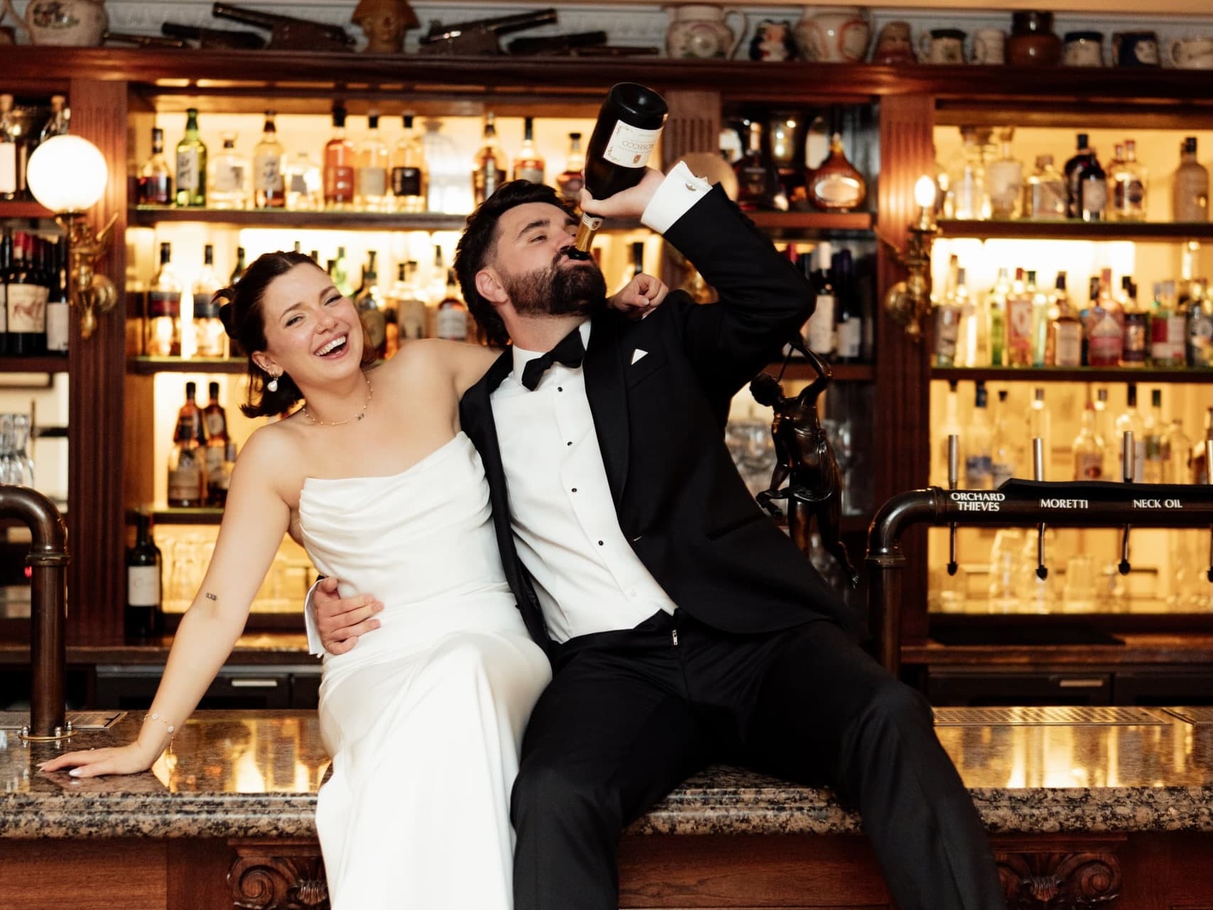 Kirsty and Jamie sharing drinks at the bar during their Trafalgar Tavern wedding reception