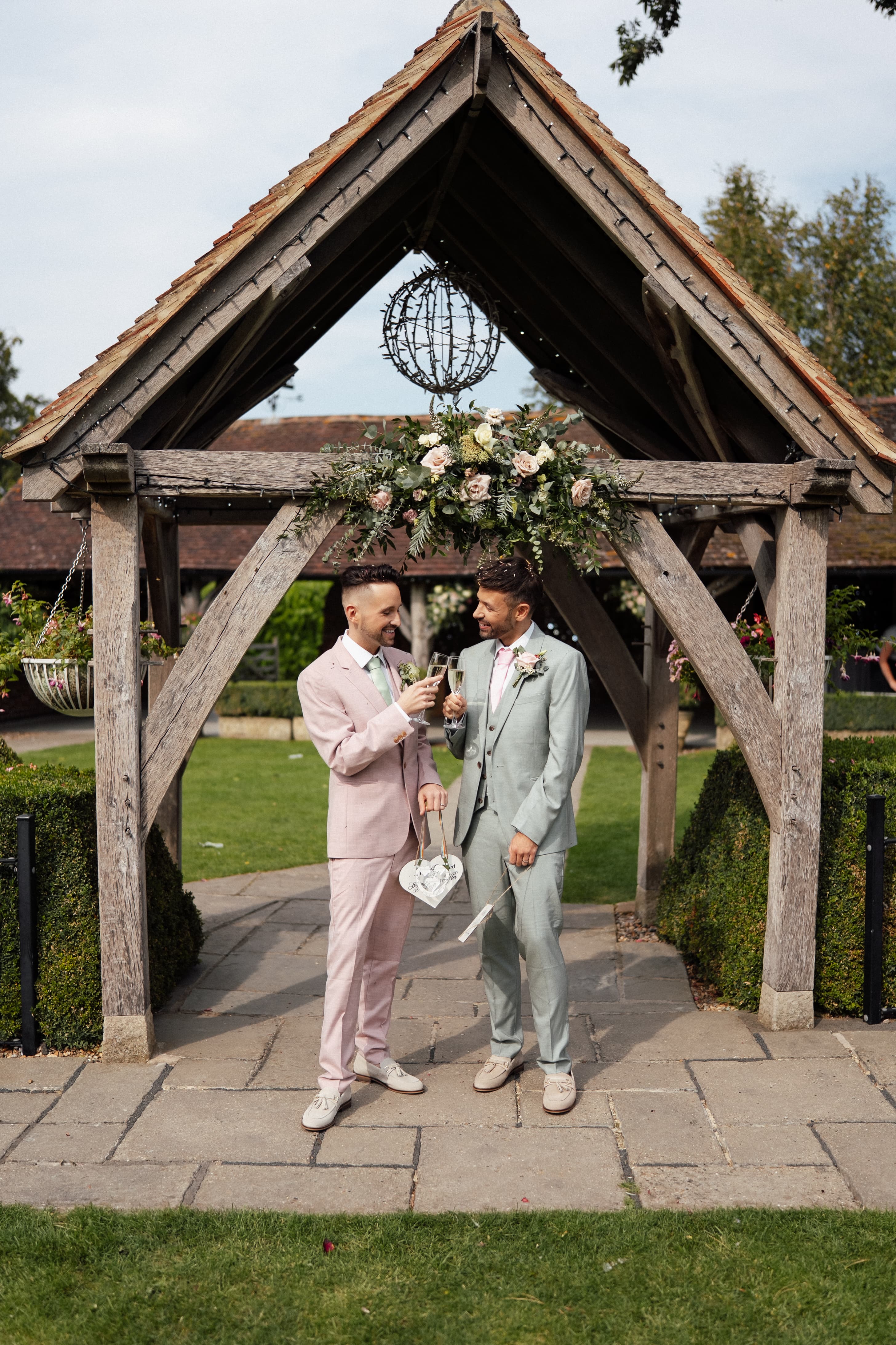 Ronnie & Danny sharing a kiss at their Winters Barns wedding with summer sunshine