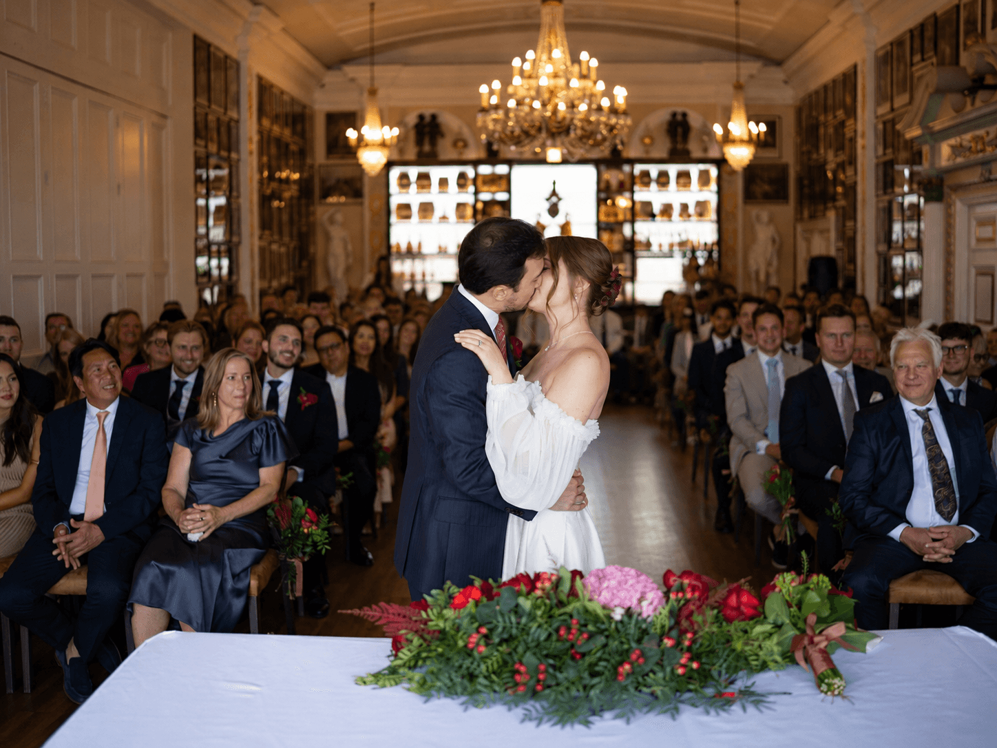 Sarah and Teddy sharing a kiss during their Trafalgar Tavern wedding ceremony in Greenwich, London